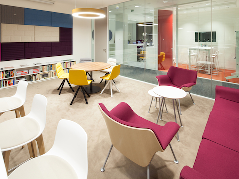 An informal meeting area featuring red Swoop Lounge Furniture.