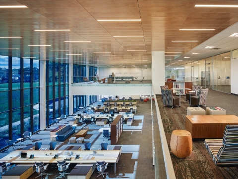 A second floor view of an open office space showing various seating arrangements.