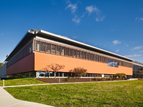 An outside view of an office building with modern architecture. An outside view of an office building with modern architecture.