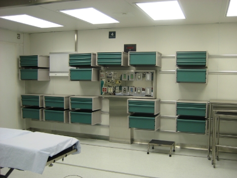 Co/Struc modular storage components line the walls of a mobile surgery unit. 