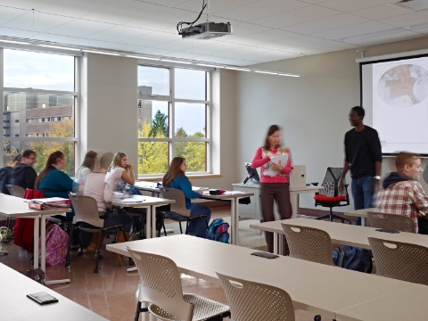 A classroom with students seated at Caper chairs and Everywhere tables.