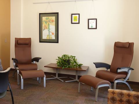 Nala patient chairs and ottomans sit inside a waiting area. Nala patient chairs and ottomans sit inside a waiting area.