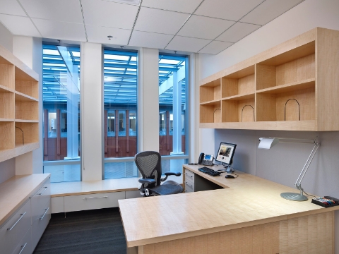 An Aeron Chair sits at a European ash veneer desk inside the Ross Building.