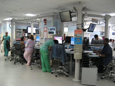 Health professionals gather around their workstations inside the Washington Hospital Center.