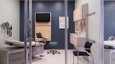 An exam room outfitted with Compass system wall-hung storage. Select to go to a white paper about designing ambulatory care facilities.