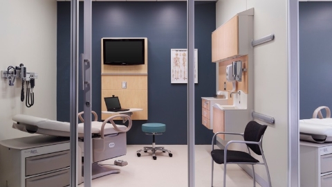 An exam room outfitted with Compass system wall-hung storage.