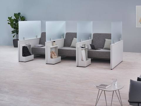 Catena Office Landscape components form three small soft seating spaces enclosed with glass screens and Ubi Mobile Bag Catch accessories. Catena Office Landscape components form three small soft seating spaces enclosed with glass screens and Ubi Mobile Bag Catch accessories.