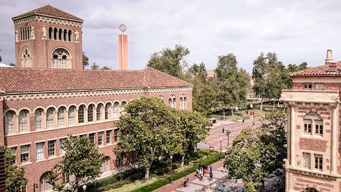 Academic buildings with tile roofs. Select to read a case study about the University of Southern California. 