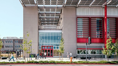Students outside a modern academic building. Select to read a case study about Herman Miller's work with The Nueva School. 