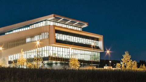 Exterior of a modern college library at night. Select to read a case study about the library at North Carolina State University. 