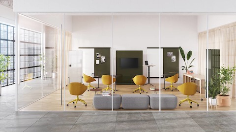 An evolved meeting space with the central conference table removed and replaced by reconfigurable furnishings like mobile whiteboards to encourage meeting attendees to make the space their own.