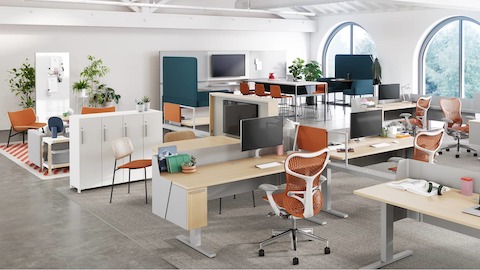 A workplace neighborhood accentuated pops of warm color to encourage positive interactions and plenty of places for team members to connect one-on-one or in small groups to discuss projects.