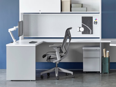 White and gray Canvas Metal Desks with overhead storage, peninsula surface, and gray Cosm Chairs.