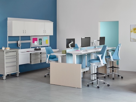 Modular Co/Struc System storage components and light blue Sayl stools in a healthcare administrative area. 