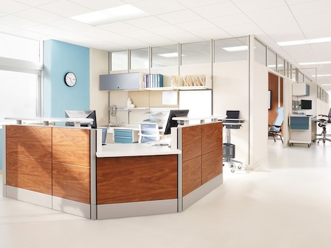 An Ethospace Nurses Station with tiles in a woodgrain finish anchors a patient floor. 