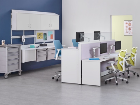 Co/Struc modular storage components, light blue Sayl stools, and green Mirra 2 office chairs in a caregiver work environment. 