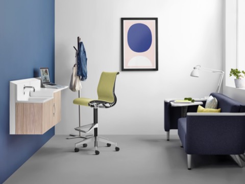 A private caregiver space featuring a blue sofa with tablet arm, green Setu stool, and Compass System storage components. A private caregiver space featuring a blue sofa with tablet arm, green Setu stool, and Compass System storage components.