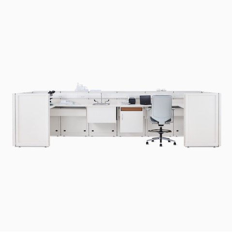 A Co/Struc System laboratory bench in soft white with under-surface storage, a sink, and a Verus Stool in light gray.