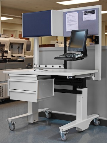 A modular, movable Co/Struc System lab work table supports a monitor and keyboard.