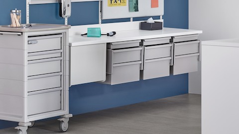 Interchangeable healthcare storage drawers from the modular Co/Struc System, including a cart and rail-hung components.