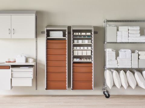 A medical clean utility supply room with a Co/Struc System wall shelving unit, procedure and supply lockers, and a stainless steel wire shelving unit.