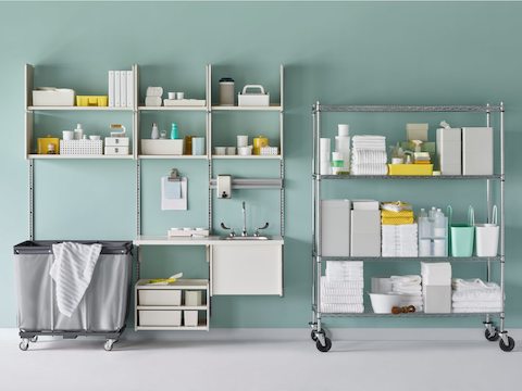 A medical soiled utility room with Co/Struc System including a sink and a stainless steel wire shelving unit.