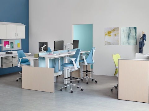 Co/Struc modular storage components, light blue Sayl Stools, and a green Mirra 2 office chair in a healthcare setting. Co/Struc modular storage components, light blue Sayl Stools, and a green Mirra 2 office chair in a healthcare setting.