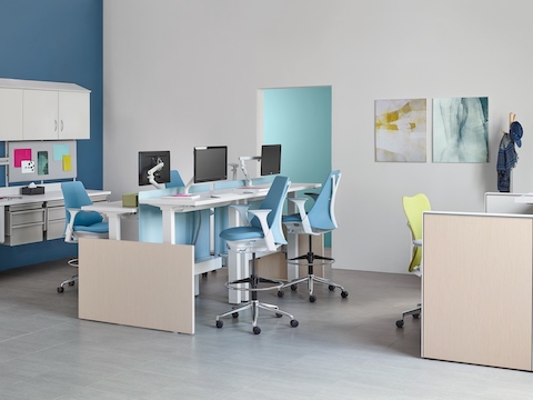 Co/Struc modular storage components, light blue Sayl Stools, and a green Mirra 2 office chair in a healthcare setting. 