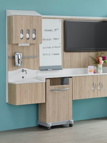 A patient room environment with a Compass System footwall in a light wood finish. A patient room environment with a Compass System footwall in a light wood finish.