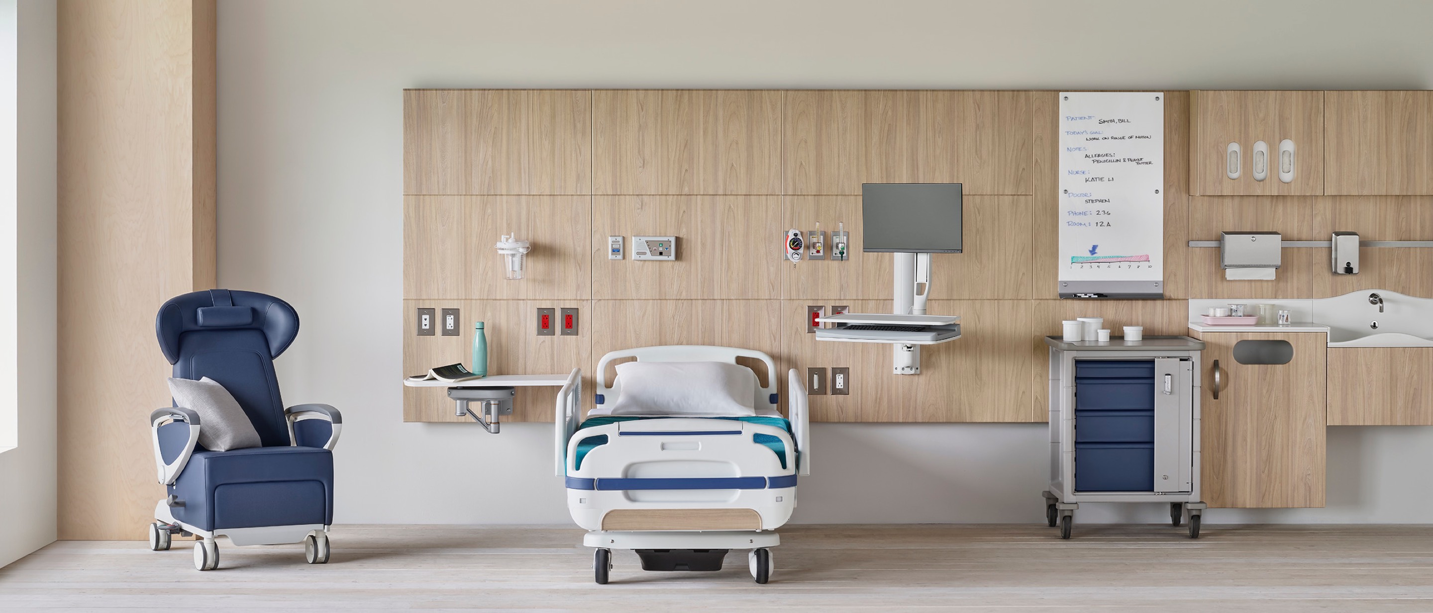 Compass System headwall in a patient room with a blue Ava Recliner with a Procedure and Supply Cart with MBrace technology support. Compass System headwall in a patient room with a blue Ava Recliner with a Procedure and Supply Cart with MBrace technology support.