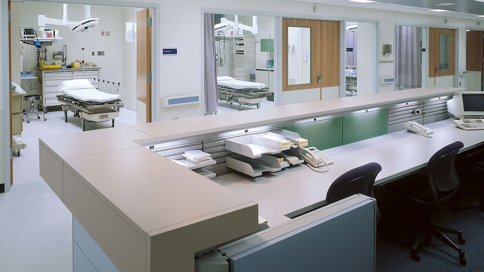 A nurses station with views into patient rooms