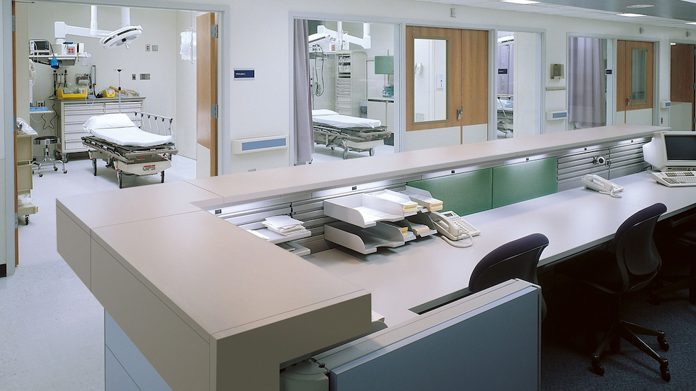 A nurses station with views into patient rooms A nurses station with views into patient rooms
