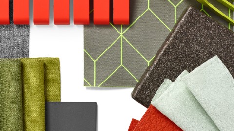 A collage of material swatches in grey, green, and a pop of red. A collage of material swatches in grey, green, and a pop of red.