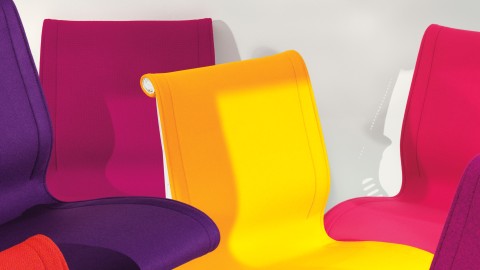 A grouping of Setu office chairs in vibrant purple, magenta, and yellow.