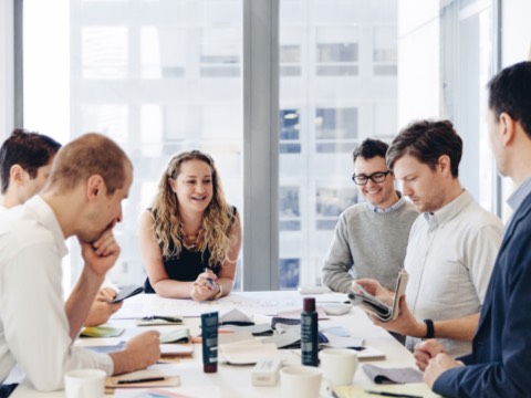 Six colleagues interact around a conference table that holds Harry's product samples. Six colleagues interact around a conference table that holds Harry's product samples.