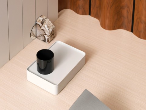 Overhead view of a white Formwork desktop storage box holding a black pencil cup and sitting on a light woodgrain surface.