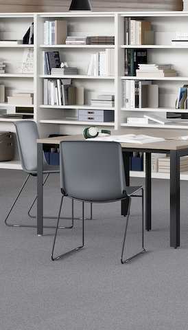 Grey Pronta Stacking Chairs in a library space with Layout Studio Tables and a NaughtOne Hue Booth.