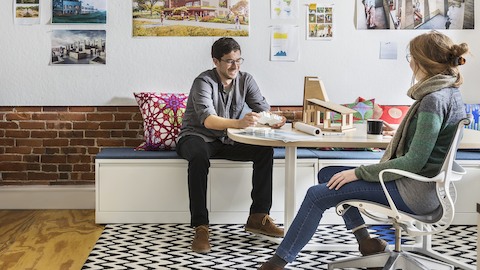 Office employees interact together while seated in Cove Setting furnishings.