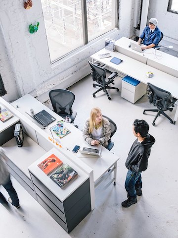 Office employees interact together while working in a casual setting.