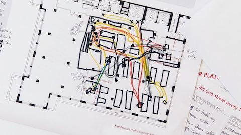 A close-up image of a blueprint with colored markings on it.