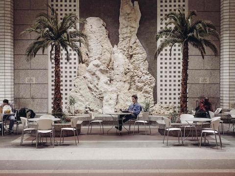 Student Thelonious Goupil reads at a public space on Wall Street.