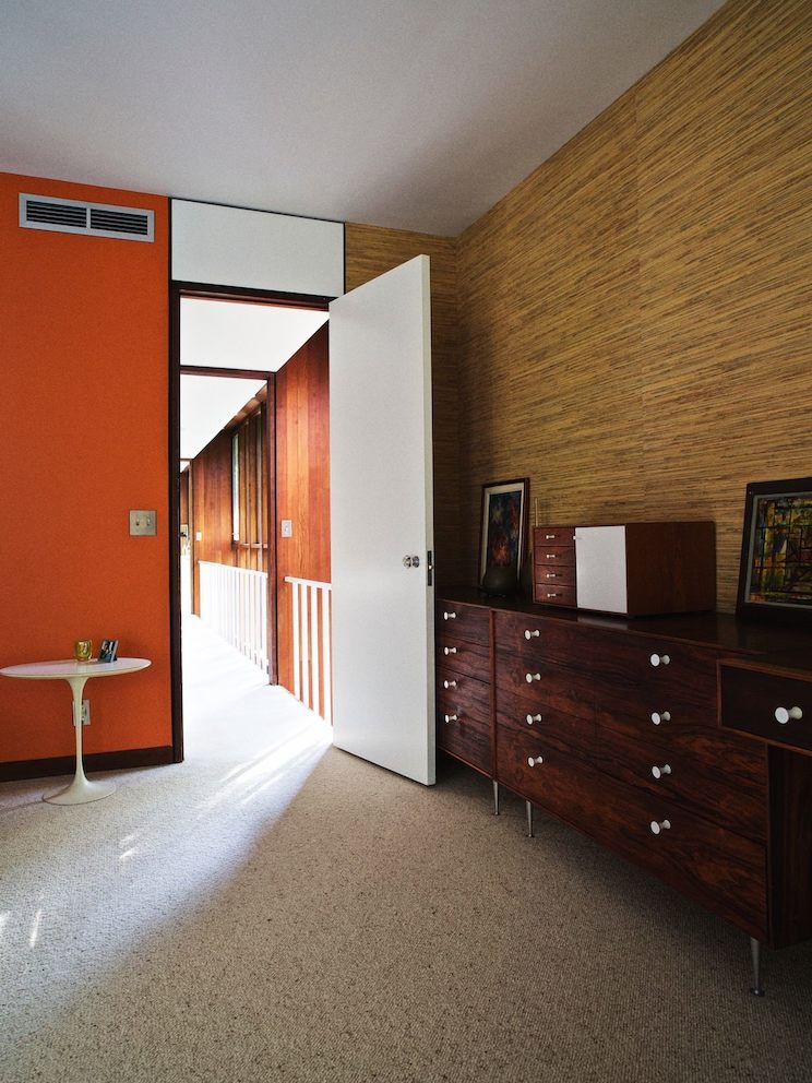 The long, light-filled hallway leads into the master bedroom.