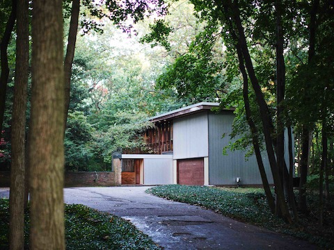 A leafy drive and lush landscape surround the Kirkpatrick House.