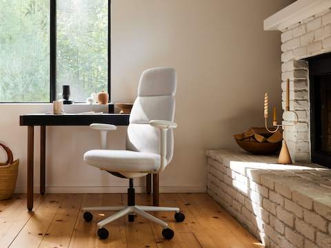 An Asari high-back chair at a Leatherwrap Desk in a home office environment.