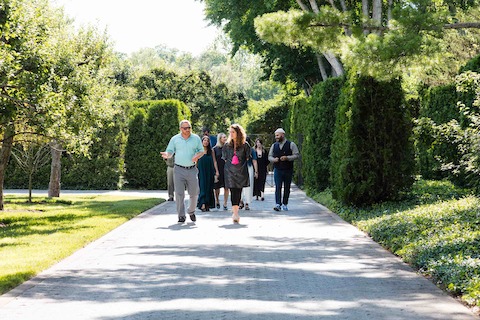 Walking outside with curators and Girard family. Walking outside with curators and Girard family.