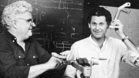 A black and white candid photo of designers Bill Stumpf and Don Chadwick with pieces of the Equa Chair prototype.