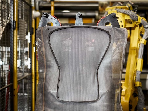 The frame of the Aeron Chair gets its mesh material added to it from heavy machinery.