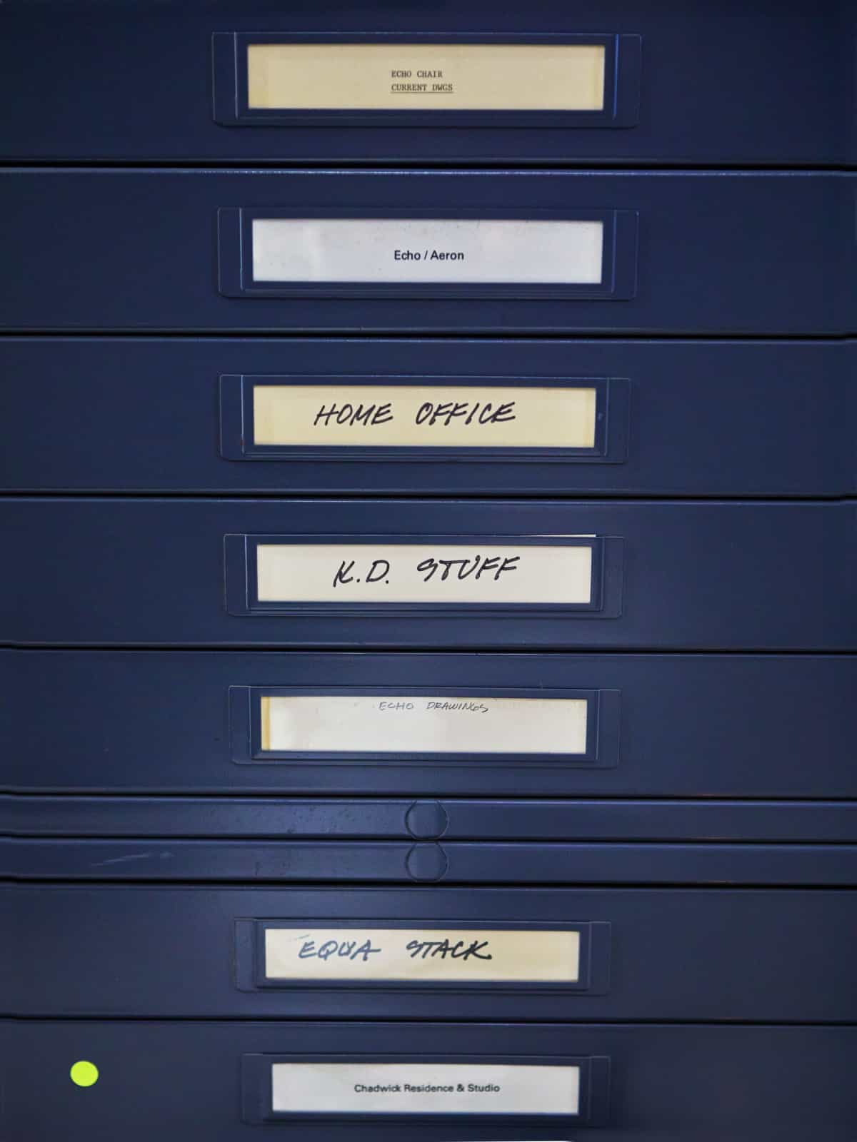 A file cabinet with many of Don Chadwick's past projects, including Aeron and Equa Chairs.