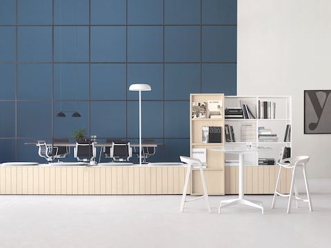 A Landing setting that utilizes Locale's Workbase as seating paired with Upper Shelving. In the background, an Eames Aluminum Group Management Chairs make for an ideal Meeting Space setting.