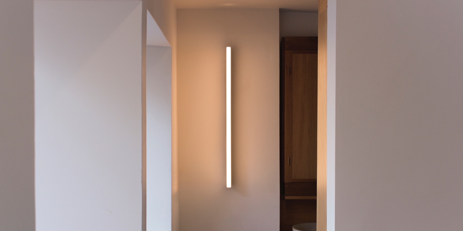 A front view of a Tube Wall Light in the London home of designer Michael Anastassiades.